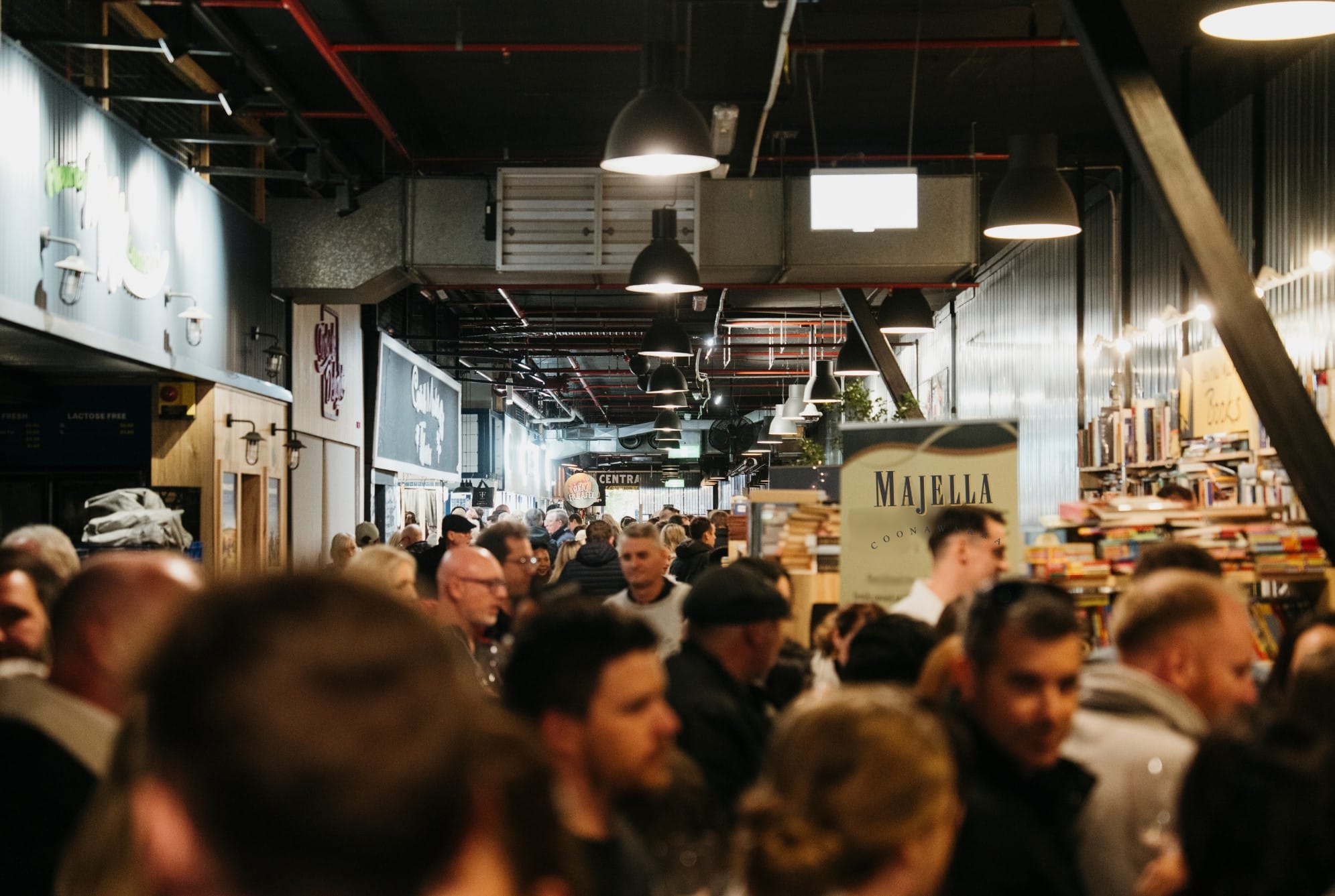 central-market-coonawarra-event People in foreground with bookshop and market stalls in background.